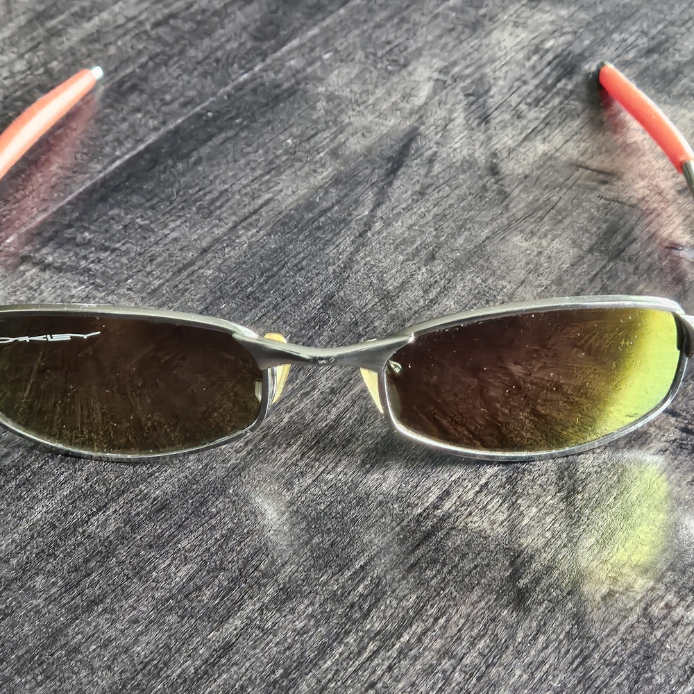 Oakley Sunglasses with Red Temples and Silver Frame